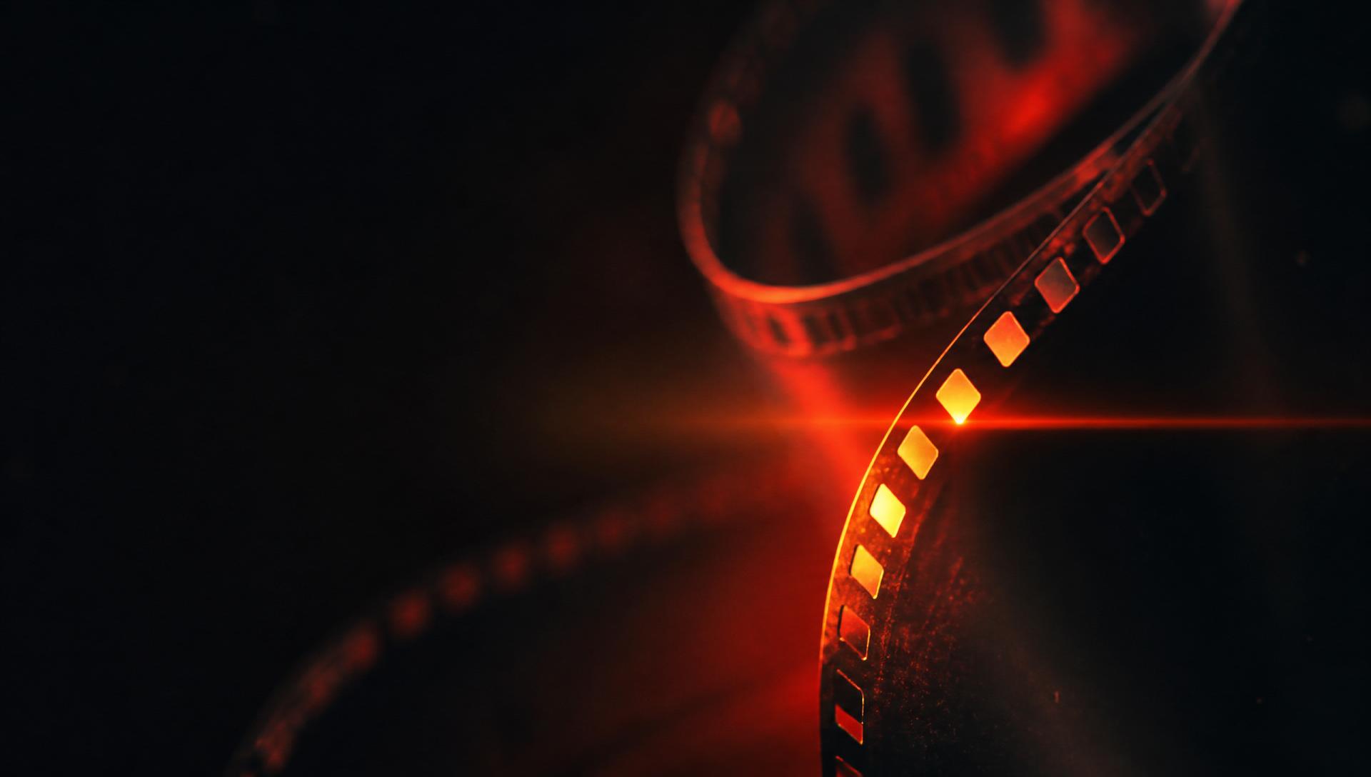 Cinematic film reel glowing in the dark, Filme videography studio Hyderabad